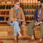 two man having a conversation in a shoe store